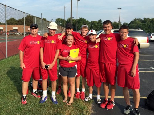 Coach Des with a group of Varsity players and 